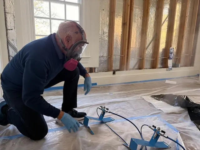 A restoration technician setting drying equipment in a Fort Collins home stripped to the studs